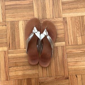 Silver and brown flip flops